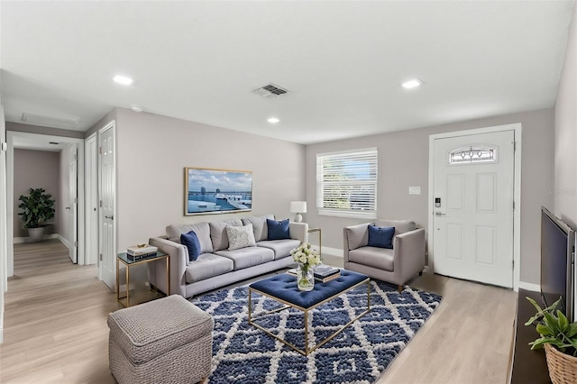 13704 Evelane Dr, Hudson, FL 34667 - living room with light wood-style flooring, baseboards, and recessed lighting