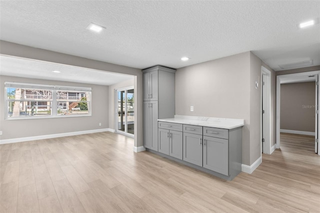 13704 Evelane Dr, Hudson, FL 34667 - bar area with light wood-type flooring, a textured ceiling, baseboards, and recessed lighting