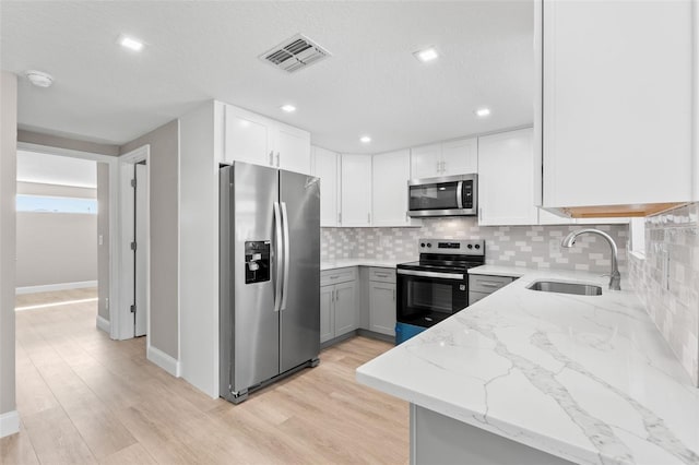 13704 Evelane Dr, Hudson, FL 34667 - kitchen with stainless steel appliances, a sink, light stone countertops, decorative backsplash, and recessed lighting