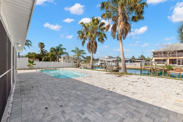 13704 Evelane Dr, Hudson, FL 34667 - view of swimming pool with a water view, a patio, a boat dock, fence, and boat lift