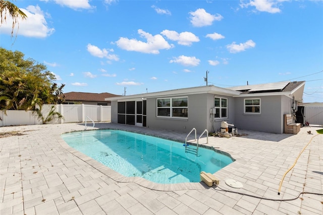 13704 Evelane Dr, Hudson, FL 34667 - view of swimming pool featuring a sunroom, a fenced backyard, and a patio area