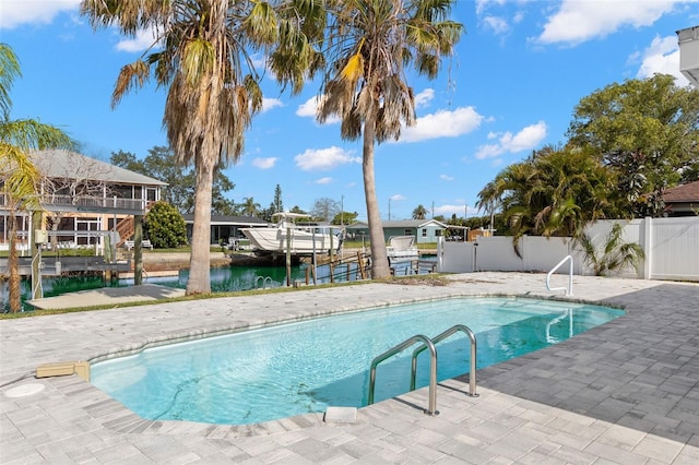 13704 Evelane Dr, Hudson, FL 34667 - view of pool featuring fence, a patio, a dock, boat lift, and a water view