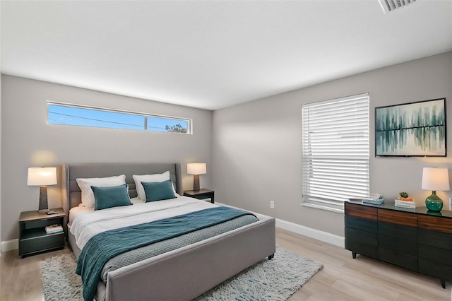 13704 Evelane Dr, Hudson, FL 34667 - bedroom with baseboards and light wood-style floors