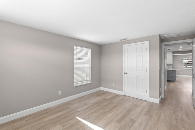 13704 Evelane Dr, Hudson, FL 34667 - unfurnished bedroom featuring light wood-style flooring and baseboards