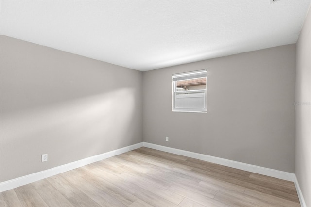 13704 Evelane Dr, Hudson, FL 34667 - empty room featuring light wood-type flooring and baseboards