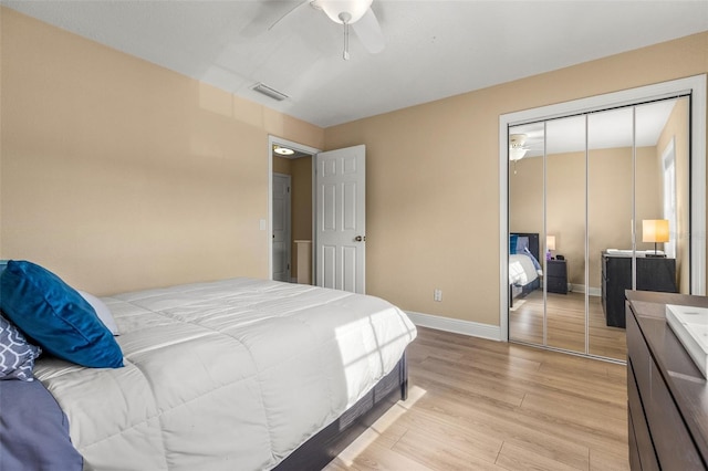 bedroom with baseboards, a closet, light wood-style flooring, and visible vents