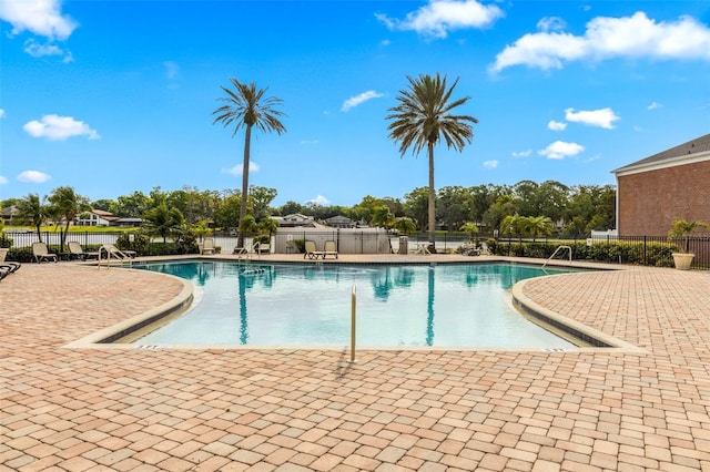 pool featuring a patio area and fence