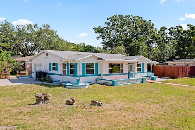 view of front of house featuring a garage, a front lawn, fence, and concrete driveway