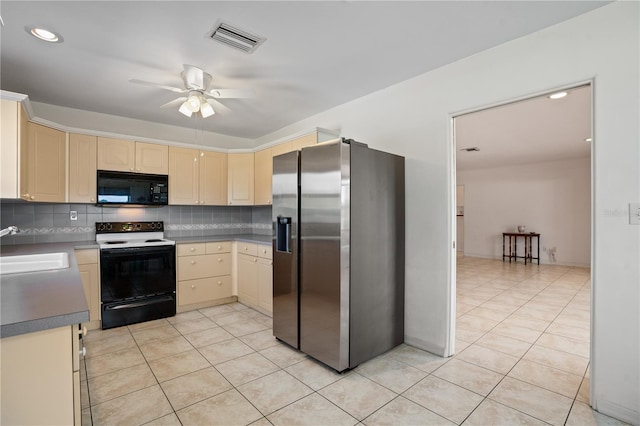 kitchen featuring black microwave, stainless steel fridge, a sink, a ceiling fan, and range with electric stovetop