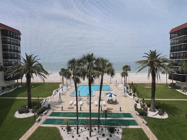 18304 Gulf Blvd Unit 309, Redington Shores, FL 33708 - view of pool with shuffleboard and a lawn