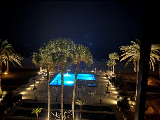 18304 Gulf Blvd Unit 309, Redington Shores, FL 33708 - pool at night featuring a community pool and a patio area