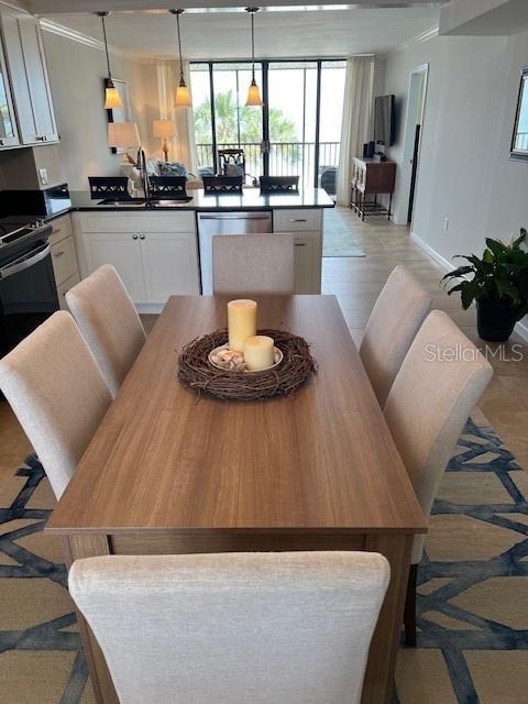 18304 Gulf Blvd Unit 309, Redington Shores, FL 33708 - kitchen with dishwasher, electric range oven, a sink, white cabinetry, and healthy amount of natural light
