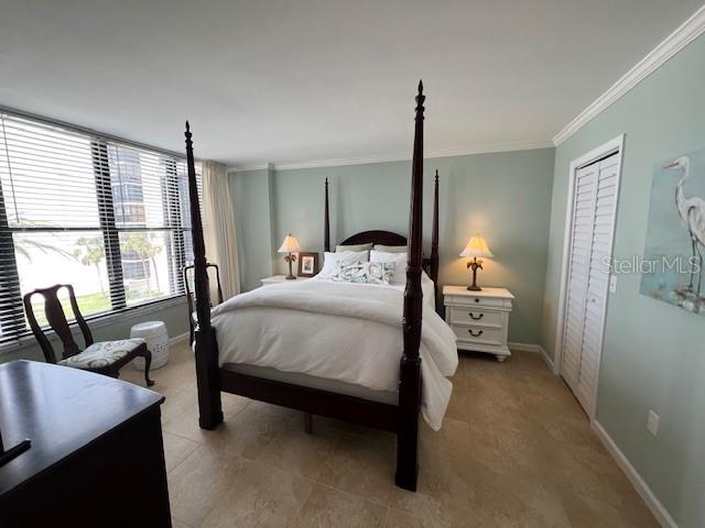 18304 Gulf Blvd Unit 309, Redington Shores, FL 33708 - bedroom with ornamental molding and baseboards