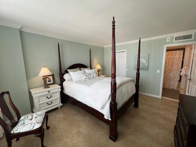 18304 Gulf Blvd Unit 309, Redington Shores, FL 33708 - bedroom featuring ornamental molding, baseboards, and light tile patterned floors