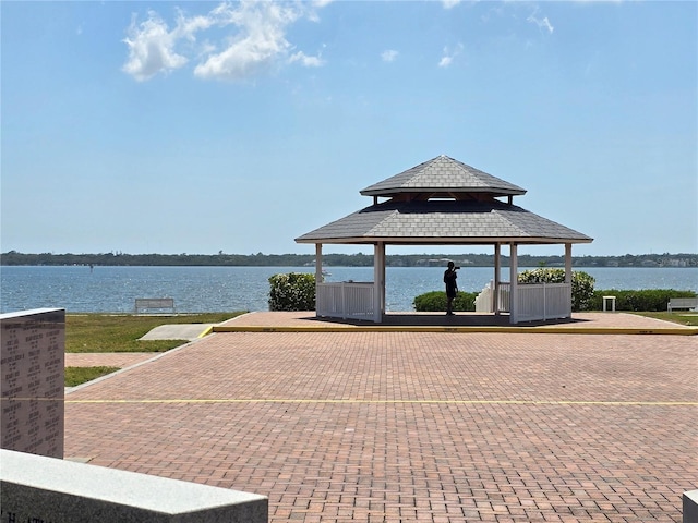 surrounding community with a gazebo and a water view