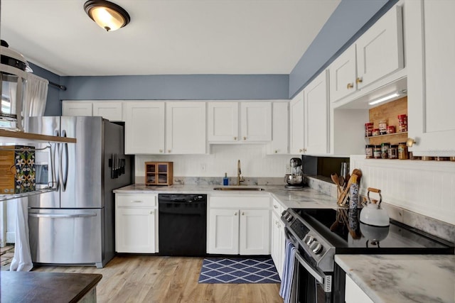 kitchen featuring range with electric cooktop, a sink, stainless steel fridge with ice dispenser, white cabinets, and black dishwasher