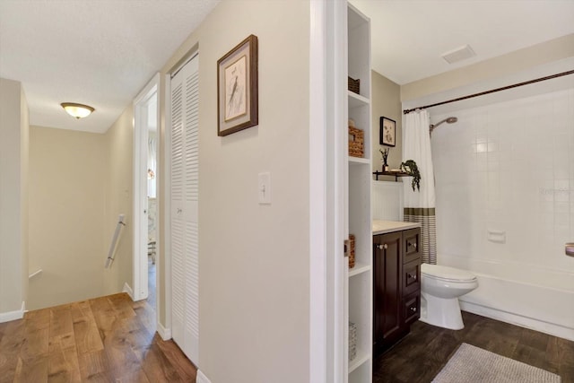 bathroom featuring vanity, a closet, toilet, and wood finished floors