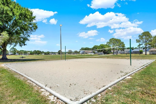 view of property's community featuring a yard and volleyball court
