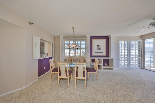 7882 Sailboat Key Blvd S Unit 401, South Pasadena, FL 33707 - carpeted dining area with baseboards, a wealth of natural light, and ceiling fan with notable chandelier