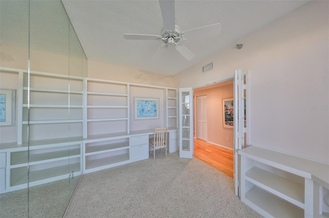 7882 Sailboat Key Blvd S Unit 401, South Pasadena, FL 33707 - empty room featuring carpet flooring, ceiling fan, a textured ceiling, built in shelves, and visible vents