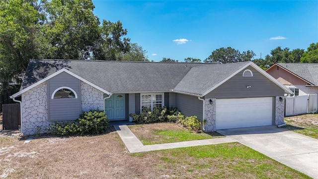 1005 Cameo Crest Ln, Valrico, FL 33596 - single story home featuring stone siding, an attached garage, fence, driveway, and a shingled roof