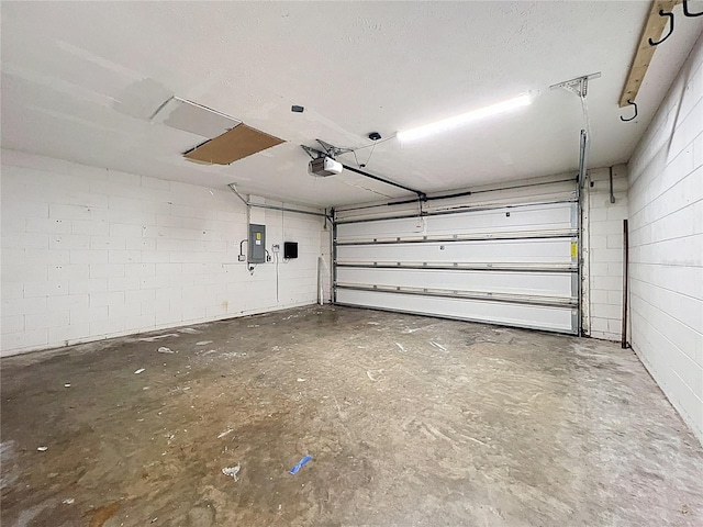 1005 Cameo Crest Ln, Valrico, FL 33596 - garage featuring a garage door opener, concrete block wall, and electric panel