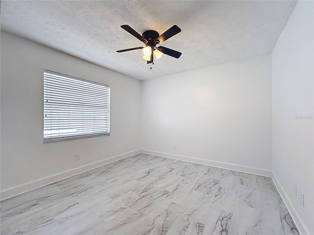 1005 Cameo Crest Ln, Valrico, FL 33596 - unfurnished room featuring light marble finish flooring, a ceiling fan, a textured ceiling, and baseboards