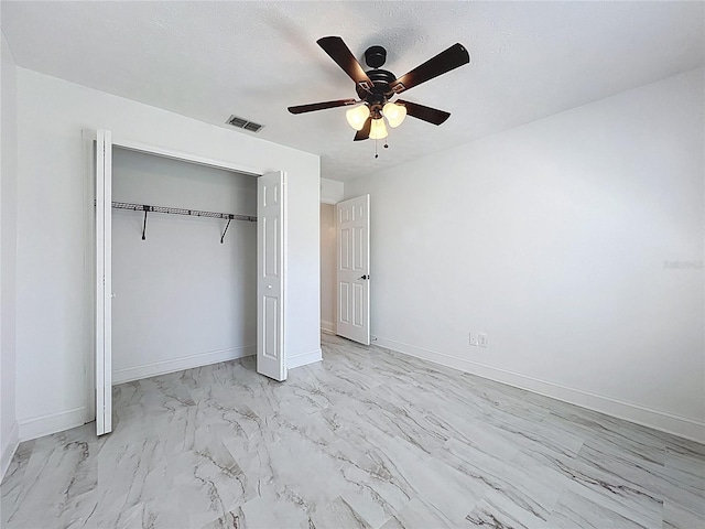 1005 Cameo Crest Ln, Valrico, FL 33596 - unfurnished bedroom featuring marble finish flooring, a closet, a ceiling fan, and baseboards