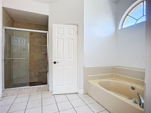 1005 Cameo Crest Ln, Valrico, FL 33596 - full bathroom featuring tile patterned flooring, a shower stall, and a garden tub