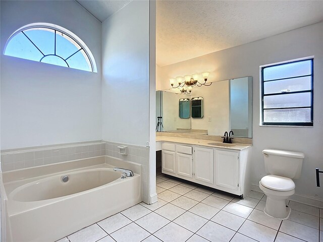1005 Cameo Crest Ln, Valrico, FL 33596 - bathroom with tile patterned floors, a bath, vanity, toilet, and a textured ceiling