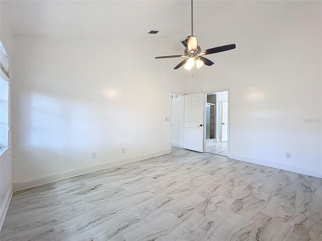 1005 Cameo Crest Ln, Valrico, FL 33596 - spare room featuring a ceiling fan, high vaulted ceiling, baseboards, and light marble finish floors