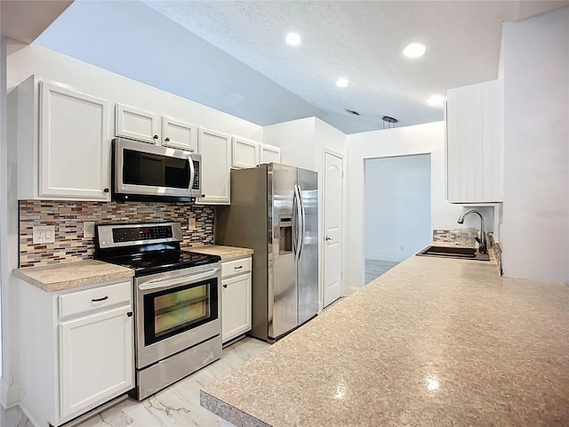 1005 Cameo Crest Ln, Valrico, FL 33596 - kitchen featuring appliances with stainless steel finishes, a sink, backsplash, recessed lighting, and white cabinets