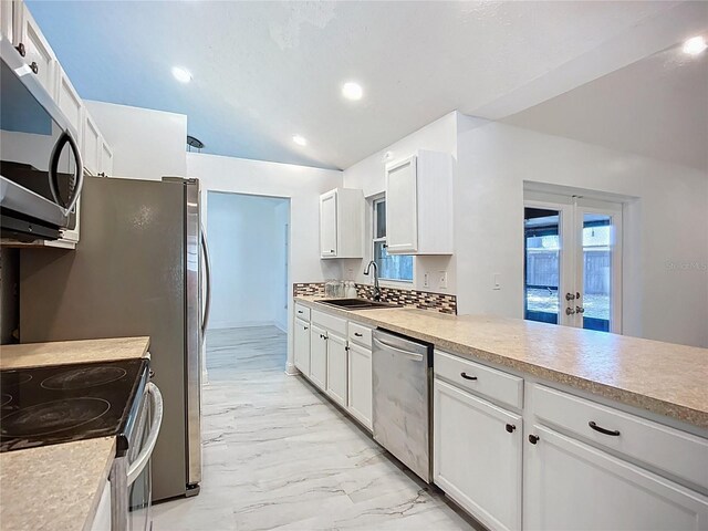 1005 Cameo Crest Ln, Valrico, FL 33596 - kitchen featuring appliances with stainless steel finishes, a sink, light marble finish floors, recessed lighting, and white cabinetry