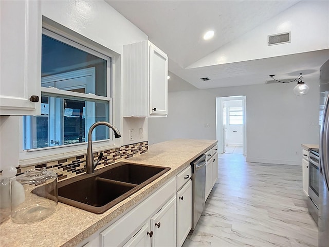 1005 Cameo Crest Ln, Valrico, FL 33596 - kitchen with a sink, vaulted ceiling, white cabinetry, backsplash, and appliances with stainless steel finishes