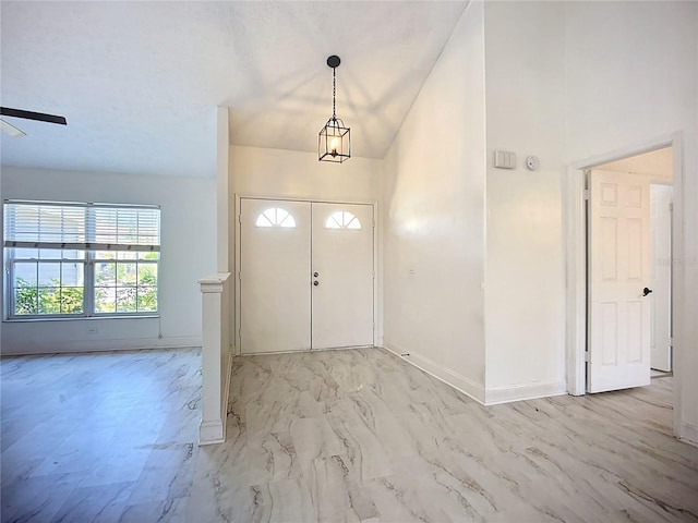 1005 Cameo Crest Ln, Valrico, FL 33596 - entryway with baseboards, light marble finish flooring, ceiling fan, and high vaulted ceiling