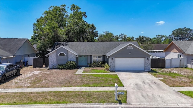 1005 Cameo Crest Ln, Valrico, FL 33596 - ranch-style home with an attached garage, concrete driveway, stone siding, and a gate