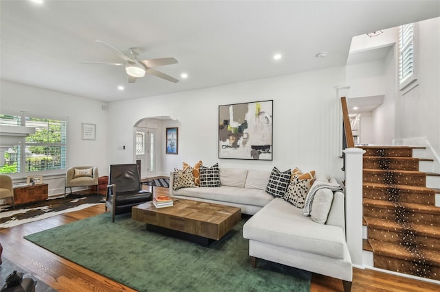 living area with arched walkways, a ceiling fan, recessed lighting, and wood finished floors
