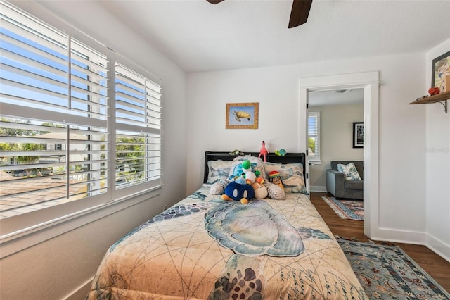bedroom with baseboards, a ceiling fan, and wood finished floors