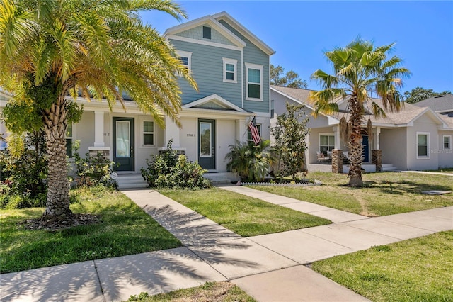 view of front of home featuring stucco siding and a front lawn