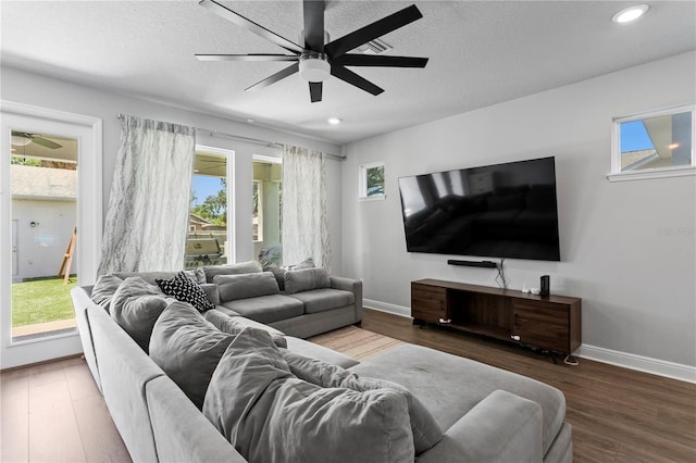 living area with a healthy amount of sunlight, a ceiling fan, and wood finished floors