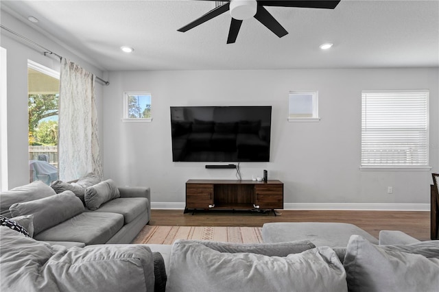 living area featuring baseboards, recessed lighting, ceiling fan, and wood finished floors