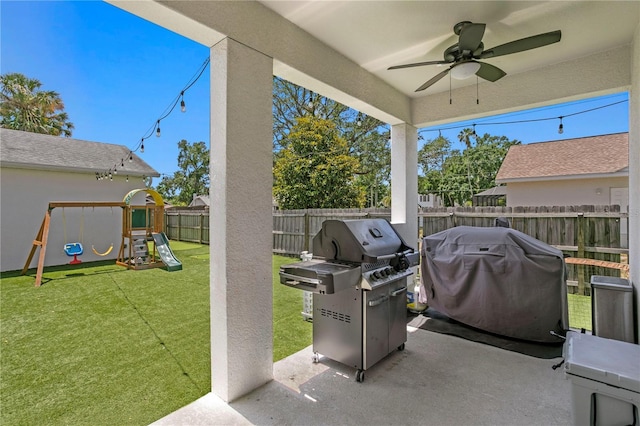 view of patio with a fenced backyard, ceiling fan, a playground, and a grill