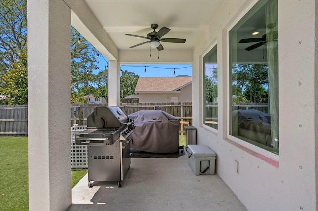 view of patio / terrace with grilling area, a ceiling fan, and a fenced backyard