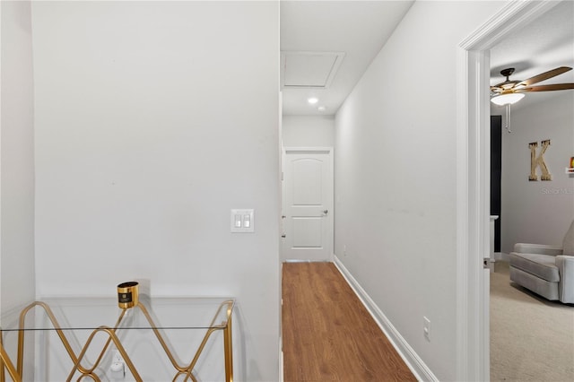 corridor with baseboards, recessed lighting, and wood finished floors