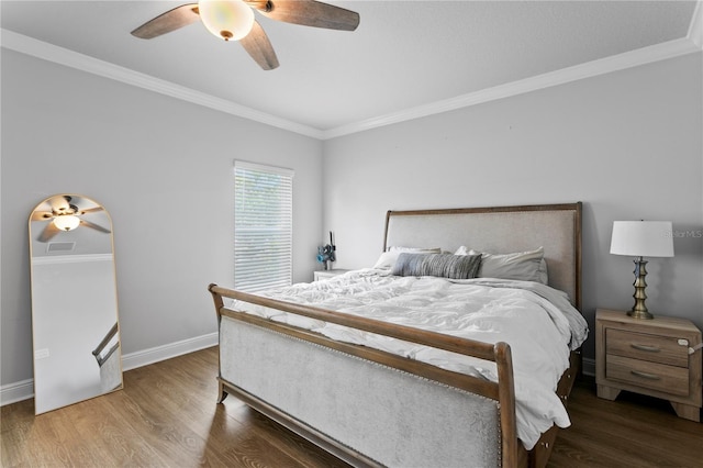 bedroom with crown molding, baseboards, a ceiling fan, and wood finished floors