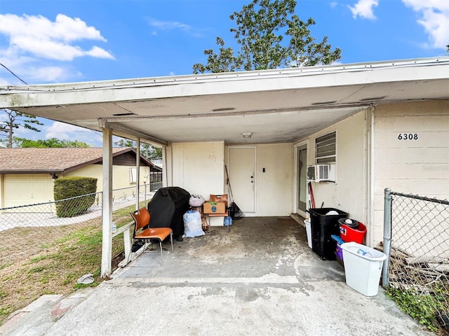 view of parking / parking lot with fence and a carport