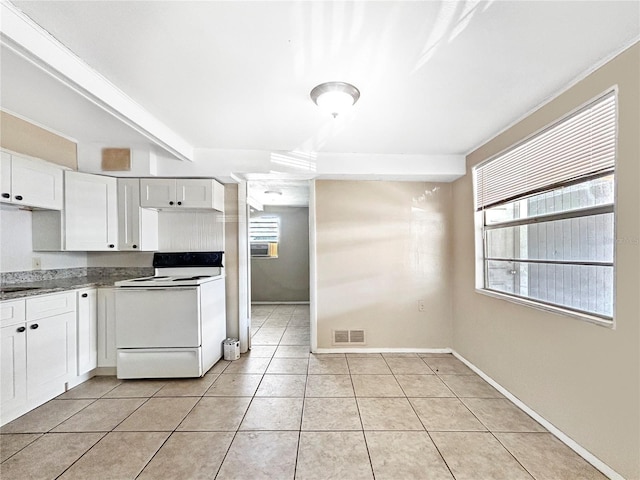 kitchen with visible vents, light tile patterned flooring, baseboards, white electric range oven, and white cabinets