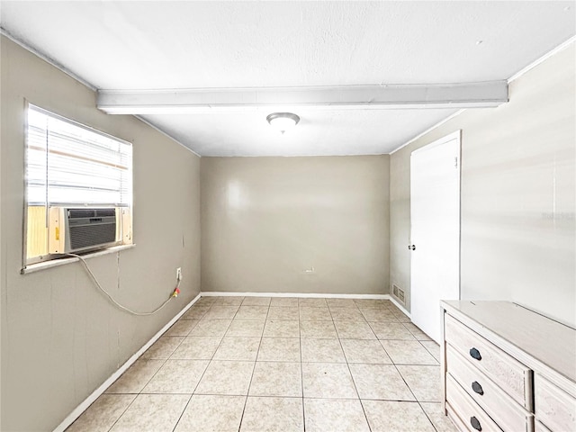 unfurnished room featuring baseboards, light tile patterned floors, cooling unit, and beamed ceiling