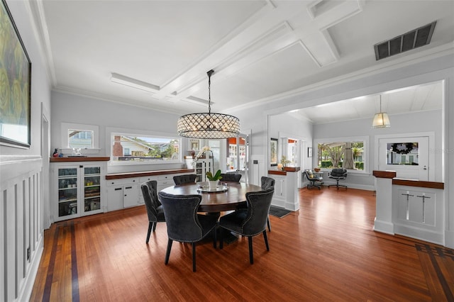 dining room featuring visible vents, crown molding, wood finished floors, beamed ceiling, and coffered ceiling