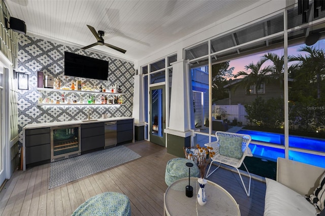sunroom / solarium featuring a sink and wine cooler